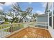 Wet wooden deck with white railings and views of neighborhood at 1663 Cultivation Ln # 455, Mount Pleasant, SC 29466