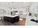 Modern kitchen with white cabinets, large island, quartz countertops, and breakfast bar at 1663 Cultivation Ln # 455, Mount Pleasant, SC 29466