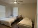 Well-lit bedroom featuring two twin beds and a ceiling fan at 1600 Long Grove Dr # 628, Mount Pleasant, SC 29464
