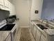 Galley kitchen with granite countertops and white cabinets at 1600 Long Grove Dr # 628, Mount Pleasant, SC 29464