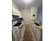 Galley kitchen with granite countertops and white cabinets at 1600 Long Grove Dr # 628, Mount Pleasant, SC 29464