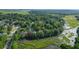 Aerial view of home on marsh with private dock; lush green surroundings at 3 Brockman Dr, Charleston, SC 29412