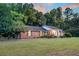 Brick home nestled in a wooded setting at dusk at 598 Maple Branch Rd, Reevesville, SC 29471
