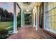Covered porch with terracotta tile and white columns at 598 Maple Branch Rd, Reevesville, SC 29471
