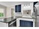 Updated kitchen with dark blue cabinets and granite countertop at 598 Maple Branch Rd, Reevesville, SC 29471