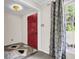 Bright entryway featuring a red door and patterned curtains at 598 Maple Branch Rd, Reevesville, SC 29471
