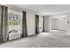 Spacious living room with large windows and neutral carpeting at 598 Maple Branch Rd, Reevesville, SC 29471