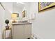 Modern powder room with stylish vanity, dark countertop, and decorative tile floor at 301 Longshore St # 423, Charleston, SC 29492