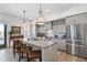 Modern kitchen with gray cabinets, island with seating, and stainless steel appliances at 301 Longshore St # 423, Charleston, SC 29492