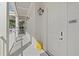Building exterior showcasing white siding, white door, and lantern lighting at 301 Longshore St # 423, Charleston, SC 29492