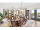 Bright dining room with hardwood floors, large windows, and a charming wooden table at 301 Longshore St # 423, Charleston, SC 29492