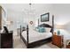 Spacious bedroom with four-poster bed, window shutters, and a neutral color scheme at 301 Longshore St # 423, Charleston, SC 29492