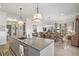 Open concept kitchen and dining area with island, stainless steel appliances, and hardwood floors at 301 Longshore St # 423, Charleston, SC 29492
