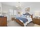 Spacious main bedroom with plush carpeting, wooden bed frame, and large window with shutters at 301 Longshore St # 423, Charleston, SC 29492