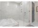 Spa-like bathroom with walk-in shower, soaking tub, and marble tile at 301 Longshore St # 423, Charleston, SC 29492