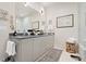 Elegant bathroom with double vanity, gray cabinets, and decorative mirrors at 301 Longshore St # 423, Charleston, SC 29492
