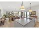 Open concept kitchen with island, dining area, and access to balcony at 301 Longshore St # 423, Charleston, SC 29492