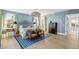 Bedroom with light wood floors, blue walls, and a patterned headboard at 228 Haddrell St, Mount Pleasant, SC 29464
