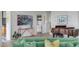 Light-filled living room featuring green sofas and a view of the kitchen at 228 Haddrell St, Mount Pleasant, SC 29464