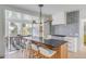 Open concept kitchen with island, white cabinets, and a patterned backsplash at 228 Haddrell St, Mount Pleasant, SC 29464