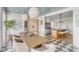 Bright dining room features a wood table, woven pendant lights, and checkered floor at 228 Haddrell St, Mount Pleasant, SC 29464