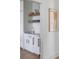White wet bar with marble countertop and open shelving at 228 Haddrell St, Mount Pleasant, SC 29464