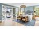 Bright bedroom with king-size bed, sitting area, and access to a private balcony with a treadmill at 228 Haddrell St, Mount Pleasant, SC 29464