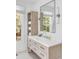 Bathroom with modern vanity, large mirror, and bright natural light at 228 Haddrell St, Mount Pleasant, SC 29464