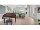 Bright living room with hardwood floors, a grand piano, and a view to the backyard at 228 Haddrell St, Mount Pleasant, SC 29464