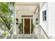 Inviting front door entrance with sidelights and charming porch at 228 Haddrell St, Mount Pleasant, SC 29464