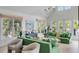 Open living room with green sofas, ample natural light and hardwood floors at 228 Haddrell St, Mount Pleasant, SC 29464