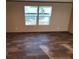 Bright living room with vinyl plank flooring and large windows at 976 S Main St, Saint Stephen, SC 29479