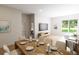 Open concept dining area with seating for eight and view into living room at 7421 Indigo Palms Way, Johns Island, SC 29455