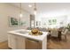Modern kitchen island with white cabinets and breakfast bar seating at 7421 Indigo Palms Way, Johns Island, SC 29455