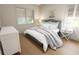 Bedroom with striped bedding and wood floors at 7421 Indigo Palms Way, Johns Island, SC 29455