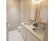 Modern bathroom with double vanity, bathtub and marble tile at 7421 Indigo Palms Way, Johns Island, SC 29455