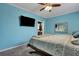 Blue bedroom with mounted TV, large bed and ensuite bathroom access at 1443 Cambridge Lakes Dr, Mount Pleasant, SC 29464