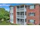 Three-story brick building with screened-in balconies and landscaping at 1443 Cambridge Lakes Dr, Mount Pleasant, SC 29464