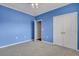 Spacious bedroom with blue walls, grey carpet, and a double door closet at 1443 Cambridge Lakes Dr, Mount Pleasant, SC 29464