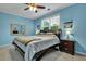 Blue bedroom with ceiling fan, dresser, and large bed at 1443 Cambridge Lakes Dr, Mount Pleasant, SC 29464