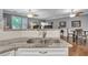 Modern kitchen with white cabinets, granite countertops, and a double sink at 1443 Cambridge Lakes Dr, Mount Pleasant, SC 29464