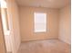 Small bedroom with window, carpet, and neutral walls at 217 Pink Azalea St, Summerville, SC 29485