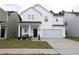 Charming two-story white house with a gray roof and attached garage at 217 Pink Azalea St, Summerville, SC 29485