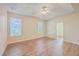 Primary bedroom with tray ceiling, wood floors, and access to another room at 195 Fox Squirrel Run, Summerville, SC 29483