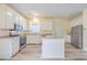 Modern kitchen with white cabinets, stainless steel appliances and breakfast bar at 195 Fox Squirrel Run, Summerville, SC 29483