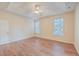 Bedroom with tray ceiling, wood floors, and two windows at 195 Fox Squirrel Run, Summerville, SC 29483