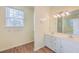 Double vanity bathroom with a large mirror and white cabinets at 195 Fox Squirrel Run, Summerville, SC 29483