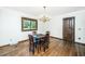 Dining room with hardwood floors, chandelier, and a window overlooking the backyard at 225 Cantering Hills Ln, Summerville, SC 29483