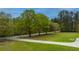 Landscaped front yard with a long driveway leading to a charming house at 225 Cantering Hills Ln, Summerville, SC 29483