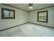 Simple bedroom with wood-paneled walls, a window, and carpeted floors at 225 Cantering Hills Ln, Summerville, SC 29483